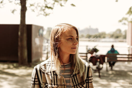 close up outdoor portrait of a woman looking aside. attractive natural young lady with smile expression