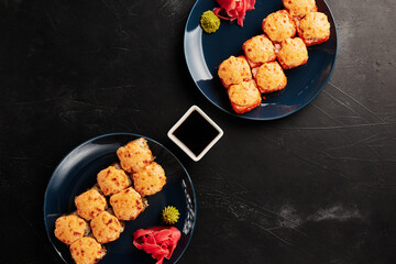 baked rolls in plates on a black textured background
