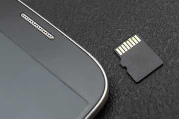 Micro SD memory card with smartphone. Close up. - obrazy, fototapety, plakaty