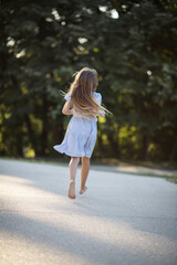  Little girl spending time in nature.