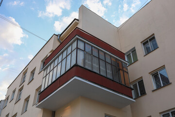 Fototapeta na wymiar Corner of a residential building in the constructivist style. Blue sky.