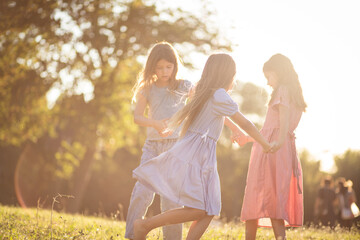 Fototapeta premium Three little girls together in nature.