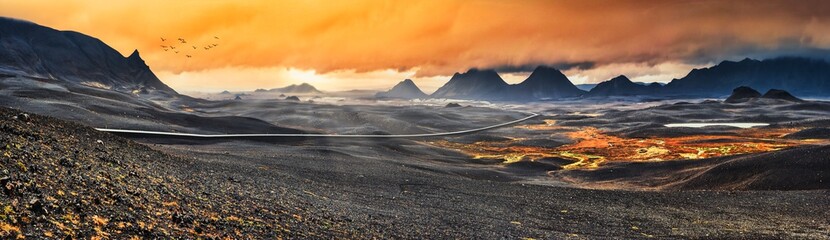 Myvatn, Iceland - Long winding road through dramatic volcanic landscape at sunset