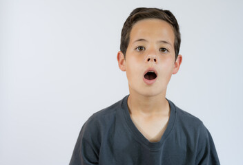 Young boy whistling and looking to the camera