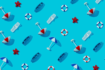 Fototapeta na wymiar Summer pattern made with beach chair, life saver float, sun umbrellas and boats on vibrant blue background. Creative vacation texture concept. Trendy minimal sea flat lay composition.