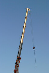Tall Jib of Construction Crane against Blue Sky