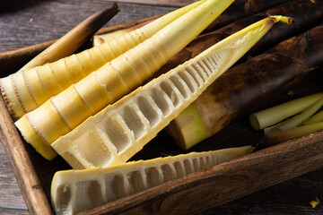 Freshly picked bamboo shoots on wood background