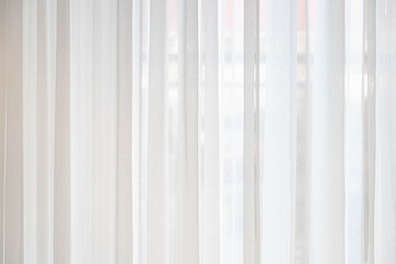 Light and see through concept, Classic white sheer curtains hanging by the window in the room with blurred view outside as background. - obrazy, fototapety, plakaty