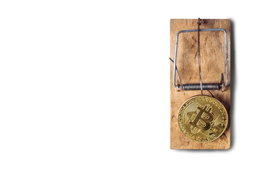 bitcoin coin in a mousetrap on a white background. Top view, flat lay