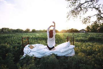 bed in a green field - 435046245