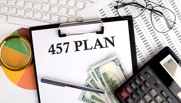 Text 457 PLAN on Office desk table with keyboard,dollars,calculator ,supplies,analysis chart on white background.