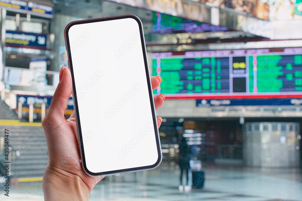 Poster mockup of a smartphone with a white screen close-up against the background of the timetable at the r