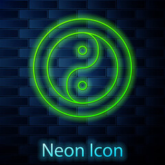 Glowing neon line Yin Yang symbol of harmony and balance icon isolated on brick wall background. Vector