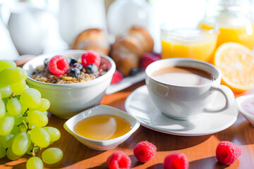 Obraz na płótnie Canvas Breakfast served with coffee, orange juice, croissants, cereals