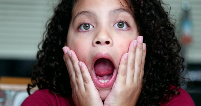 Child surprised reaction to news. excited amazed little girl