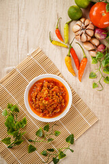 Top of View Sambal Bawang Or Spicy Onion Sauce with ingredients, Onion, Red Chilies, garlic, and salt. Sambal Bawang is favorite chili sauce in Indonesia