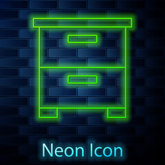 Glowing neon line Furniture nightstand icon isolated on brick wall background. Vector