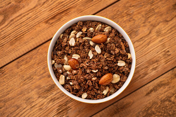 Chocolate granola with almond, nuts in a bowl
