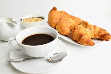 Delicious breakfast background. Tasty croissants, muesli and cofe.