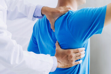 Male doctor therapist working examining treating injured back.Back pain patient, treatment, medical...