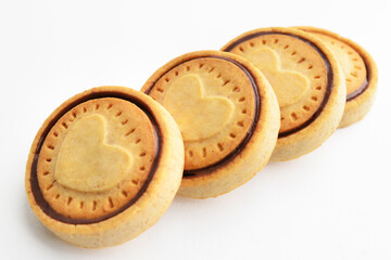 Stacked chocolate chip cookies. Symbolic image. Concept for a tasty snack. Sweet dessert. White background. Selective focus. Close up. Cookie Hearts shape.