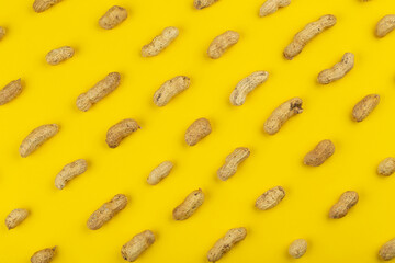 Peanuts pattern isolated on a yellow backround. Repetition concept.