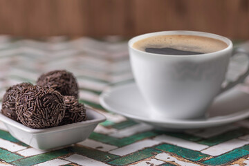 Traditional brazilian chocolate candy called "Brigadeiro" with a cup of Brazilian coffee.