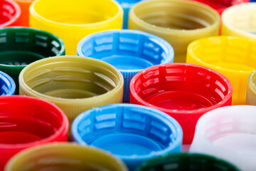 Plastic bottle caps background. Cap material is recyclable.