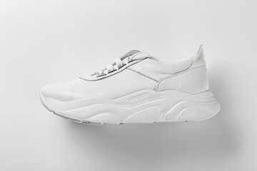 White leather sneakers on a white background. Casual style.