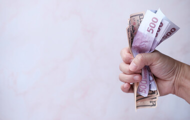Holding banknote money and saving money and business growth concept,finance and investment concept