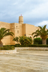 Fototapeta na wymiar The huge, majestic walls and towers of Ribat fortress on a rainy day. Ribat is an architectural jewel of Monastir, Tunisia