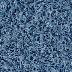 Close up of shaggy carpet texture in indigo blue