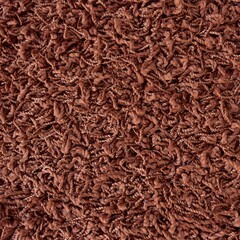 Close up of brown shaggy carpet texture