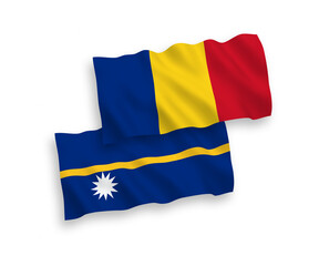 National vector fabric wave flags of Romania and Republic of Nauru isolated on white background. 1 to 2 proportion.