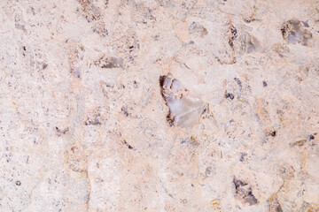 Dolomite natural stone texture. Stone with beige pattern on a smooth surface. Finishing building material.