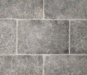 Fototapeta premium Tumbled weathered natural stone tile texture for exterior flooring