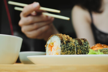 Japanese kitchen. Set of Japanese sushi and rolls. Food sticks.