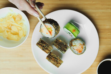 Japanese kitchen. Set of Japanese sushi and rolls. Food sticks.