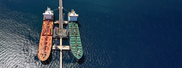 Aerial drone ultra wide photo of crude oil tankers anchored in Mediterranean industrial port