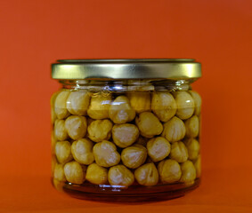 Hazelnuts filled with honey in a glass jar