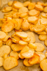 Baked sliced potatoes on a parchment paper - easy appetizer 
