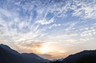 Fototapeta na wymiar sun rising blue sky over the mountain in India 