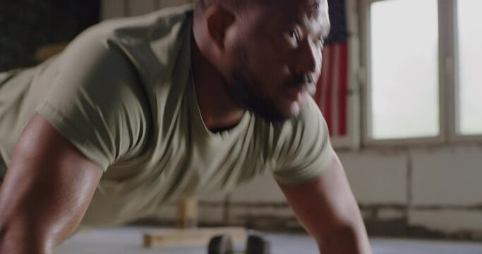 Black soldier doing push ups in gym