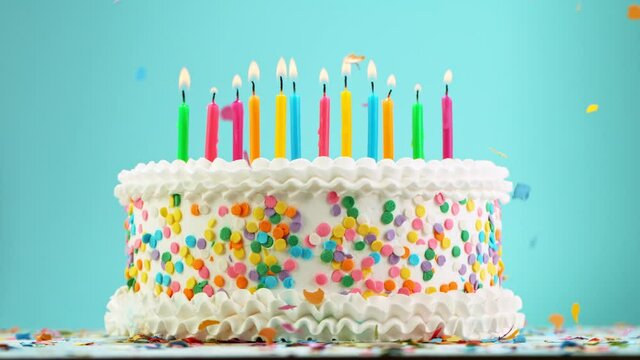 Birthday Cake With Burning Colorful Candles on Pastel Blue Background. Super Slow Motion, 1000 FPS.