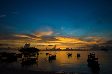 Longtail boat on the sea at sunrise in Adang-Ravi Islandsin,Tarutao National Park, Satun Thailand.