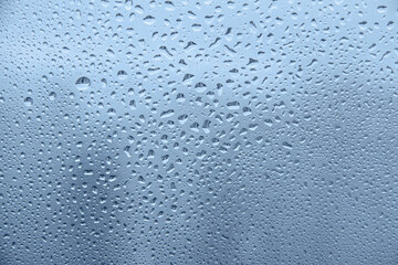 raindrops on glass window on cloudy day