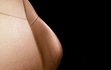 Modern luxury car brown leather interior. Part of red leather car seat details with stitching. Interior of prestige car. Comfortable perforated leather seats. Orange perforated leather.