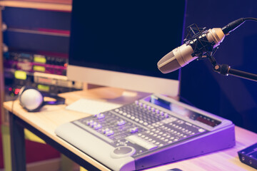 microphone, sound mixer, computer and professional sound equipment in studio. voice over or live...