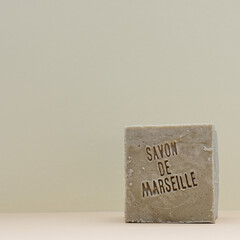 Natural soap with French language text (translate: Soap from Marseille). Traditional soap bar with copy space.