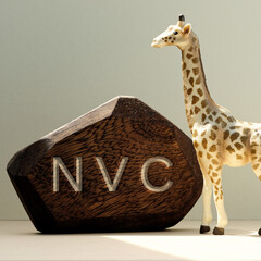 Letters NVC written on wooden irregular block. Non-violent communication concept.